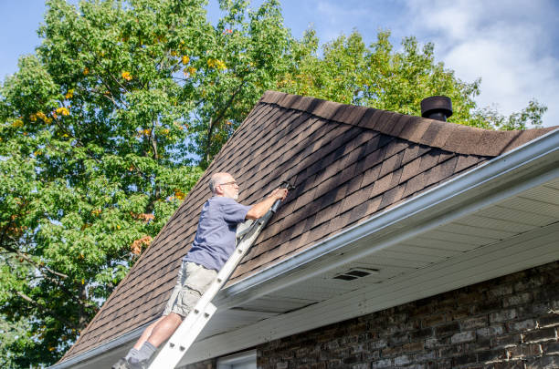 istock Mature man repairing asphalt shingle roof 1721209597