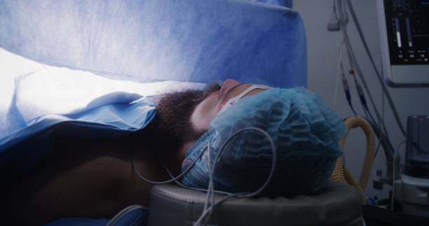istock Close up of male patient lying on table under anesthesia 1721210021