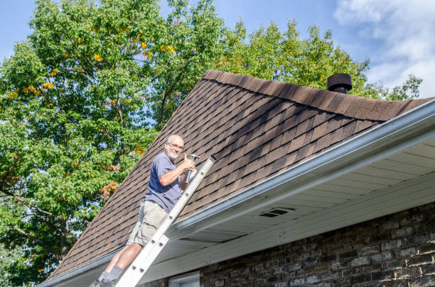 istock Mature man repairing asphalt shingle roof 1721211085