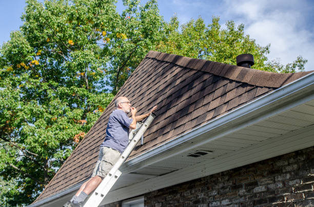 istock Mature man repairing asphalt shingle roof 1721211631