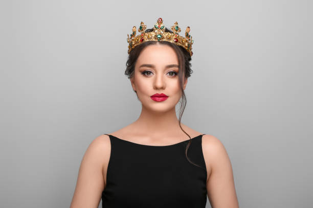 istock Beautiful young woman wearing luxurious crown on light grey background 1721212190