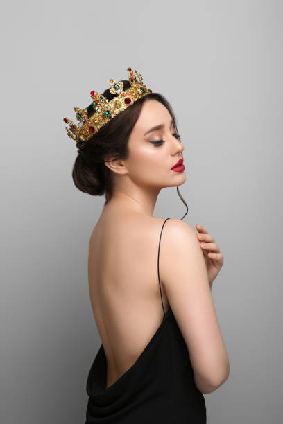 istock Beautiful young woman wearing luxurious crown on light grey background 1721212207