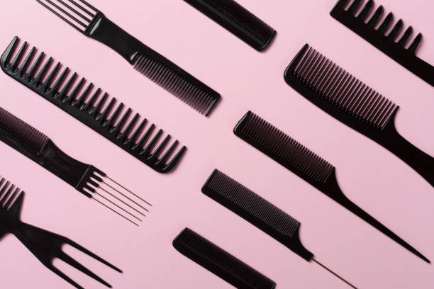 istock Professional combs and hairdresser tools on color background, top view 1721219892