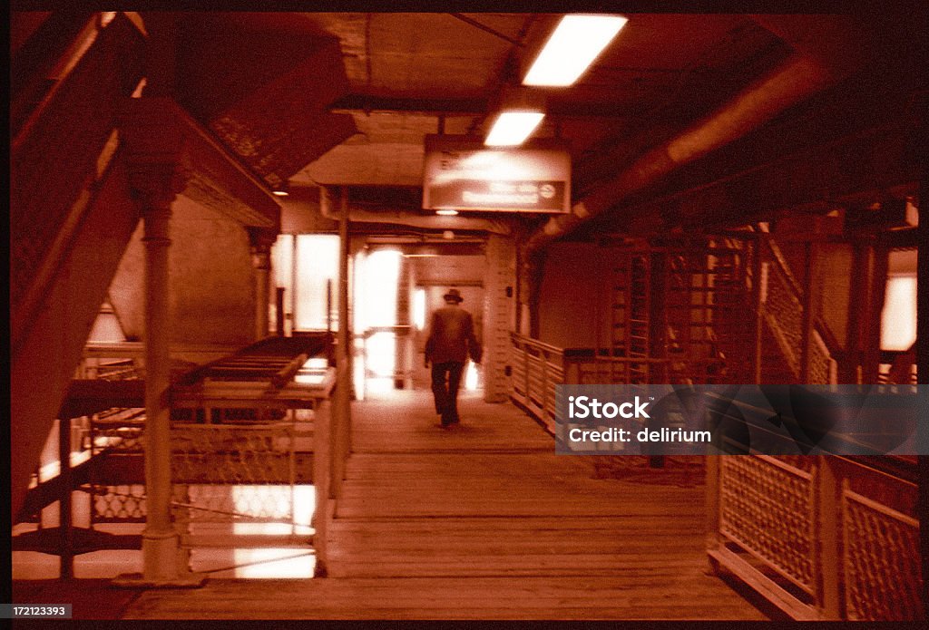 On the 'El' platform in Chicago An old man walks in uncertainty on the elevated train platform in Chicago. Adult Stock Photo