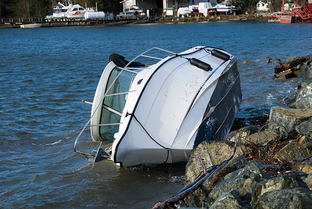 istock Lone white boat lying on its side on the water 172123497