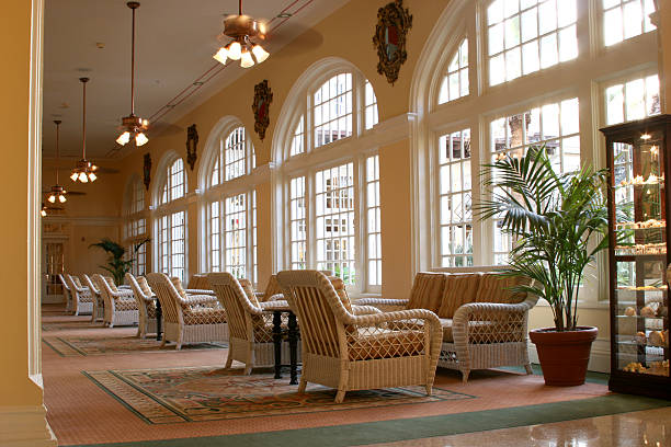 istock Hotel Lobby. Tropical setting. Rattan furniture, windows. Table,chairs. 172124623