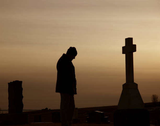 istock Man Remembering War Hero at Veteran's Cemetary 172124727