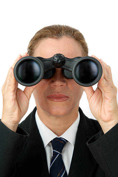 Businesswoman with binoculars