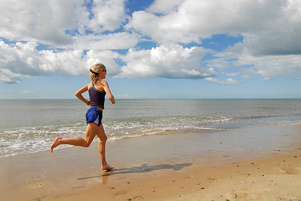 Woman Runner On Beach stock photo