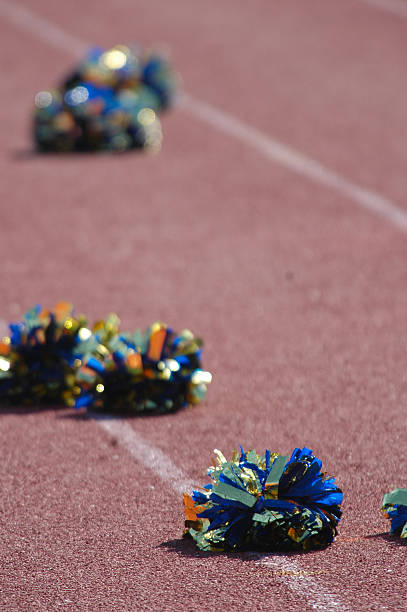 istock Cheerleader's Pom poms lay on a running track. 172124831