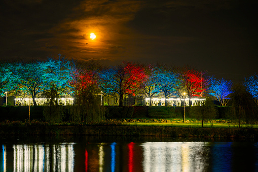 Korean Chuseok or Full Moon Holiday Nightscape over Suncheon Citys East River with trees and plants illuminated in vibrant colors at Suncheon Bay National Garden in Jeollanam-do, South Korea