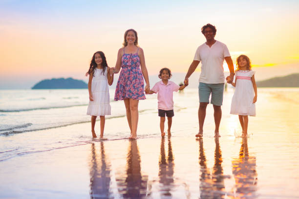istock Family walking on tropical beach at sunset 1721253330