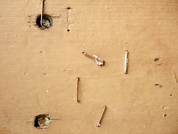 Nails used in construction, hammering wood, are rusty.