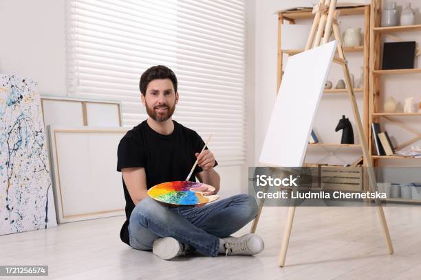 Man Using Art Tools Man With Brush And Palette Painting In Studio Using Easel To Hold ...