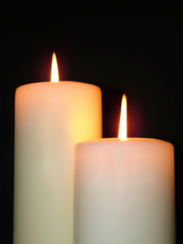 Pair of lit pillar candles.
