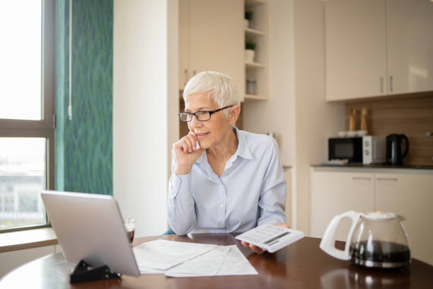 istock Senior woman is going through bills and finances 1721268863