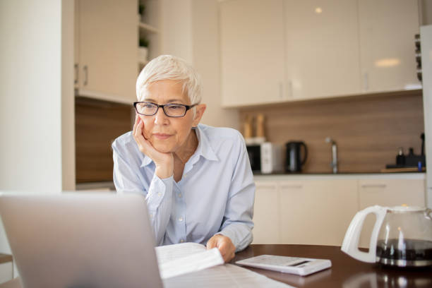 istock Senior woman is going through bills and finances 1721268868