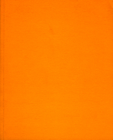 orange book cover out of textile with texture.
