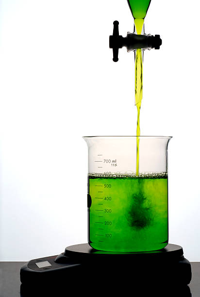 agregar verde líquido a un vaso de precipitados - beaker laboratory weight scale physics fotografías e imágenes de stock