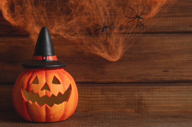 istock Jack-o-latern against the background of cobweb with two spiders. Halloween postcard. Selective focus, copy space for text 1721281682
