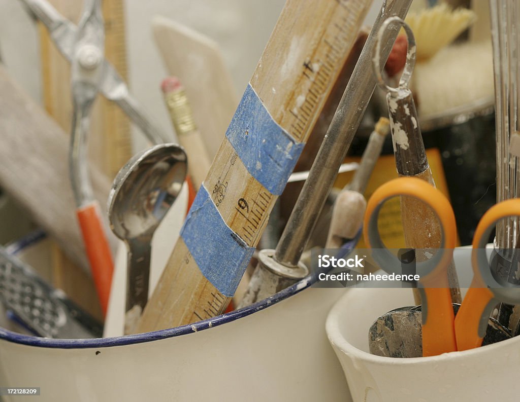 Art Supplies The supplies of an artist in cups. Scissors, a ruler, spoon, pencil with eraser. Art Stock Photo