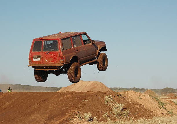 offroad racing 4x4 SUV jumping an obstacle  hopper car stock pictures, royalty-free photos & images