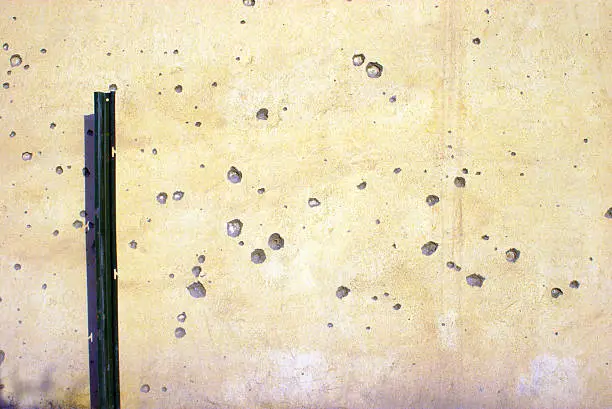 Bullet Holes and Shrapnel damage in wall on U.S. Base in Iraq. 