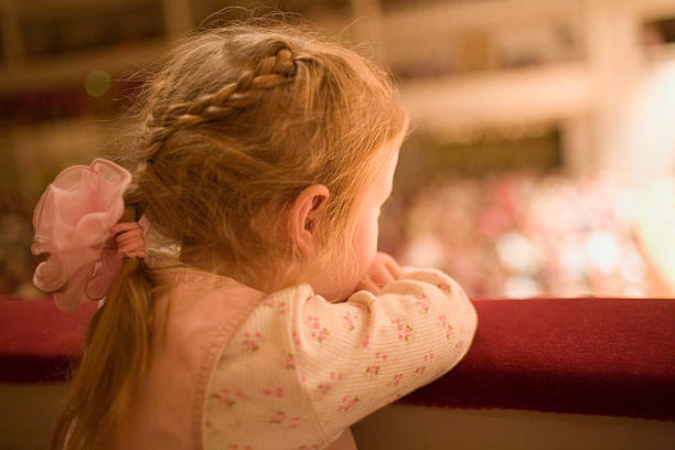Little girl at the theater stock photo