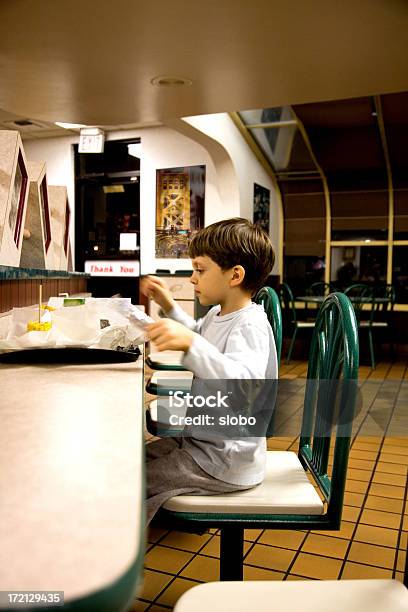 Giovane Ragazzo Avendo Una Nottata Spensierata Mangiare Fast Food - Fotografie stock e altre immagini di Bambino