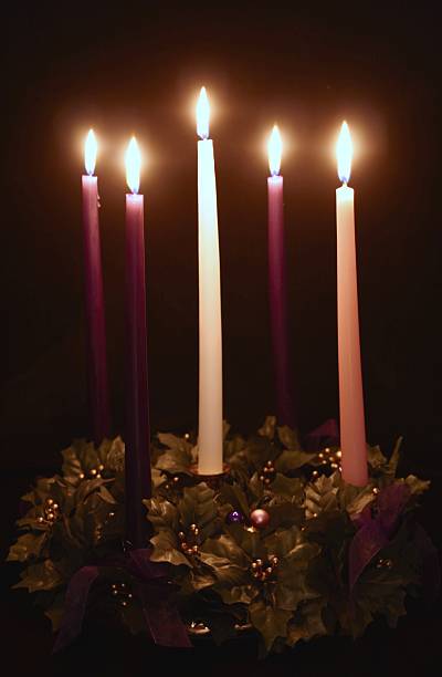 5 candle Advent wreath includes 3 purple, 1 pink, 1 white candles arranged on a decorated wreath on black background. Vertical image would be good for Christian or religious Christmas use. For more advent wreaths and Christian Christmas images click below.