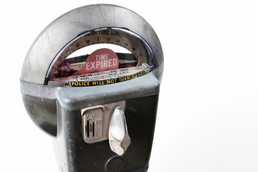 Coin operated parking meter that took pennies, nickles and dimes.  Park for 2 hours on 10 cents. Antique, old, vintage. White background.