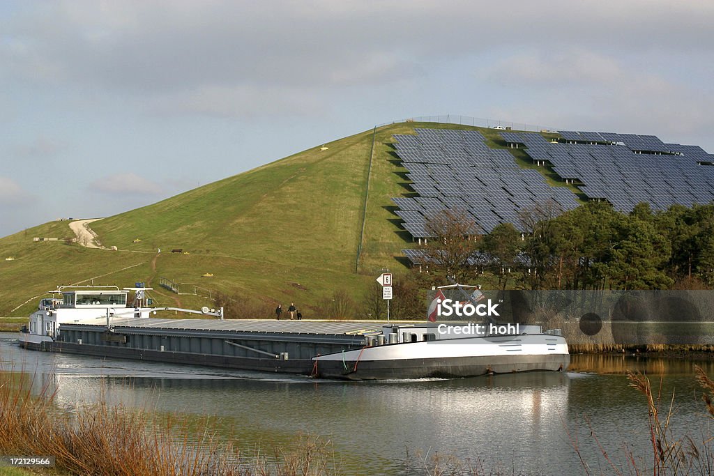 barge and solar power station solar panels on a hill in Fuerth, Franconia, Germany and canal boat Fuerth Stock Photo