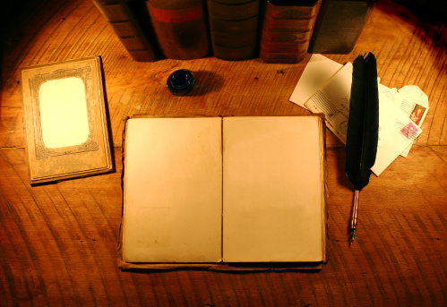Great starter image for a vintage interface.  Photo includes empty antique photo frame, handmade antique empty scrapbook with textured pages (pages are stained and held together with twin), feather ink pen, two vintage envelopes all in front of a row of antique books.  Have fun.