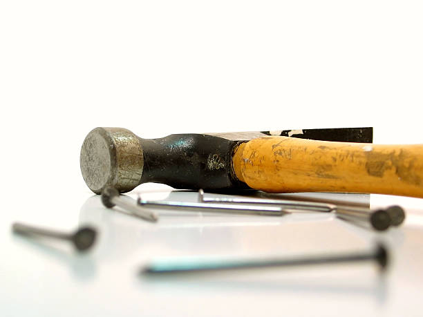 Hammer & Nails A composed still image of an old hammer and scattered nails. wack stock pictures, royalty-free photos & images