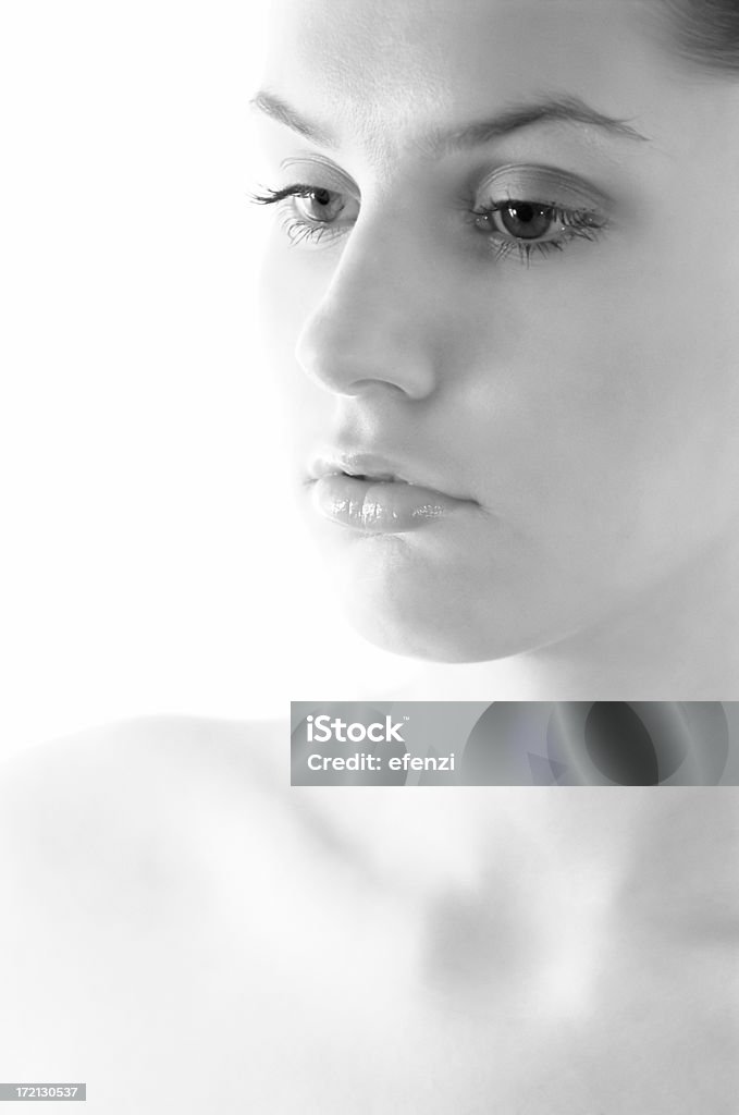 Head and shoulder Close-up portrait of a young woman. Focus is set on her eyes. Adult Stock Photo