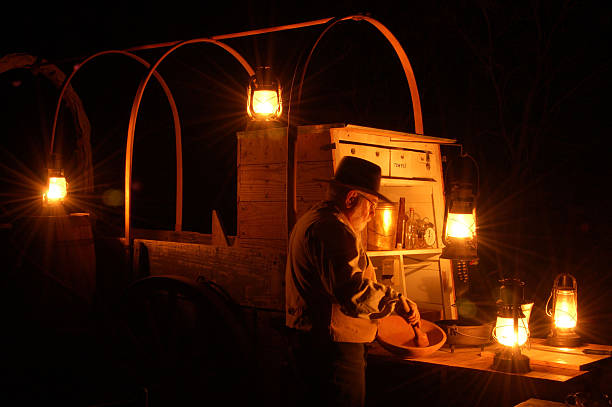 Night Cooking Mixing biscuits after dark on a chuck wagon. chuck wagon stock pictures, royalty-free photos & images