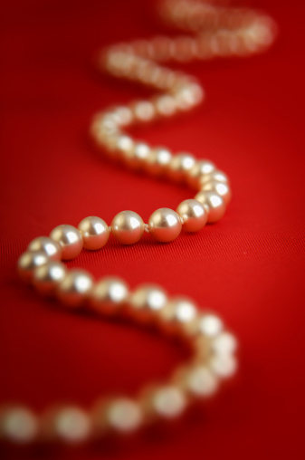 Pearls on red background. DOF