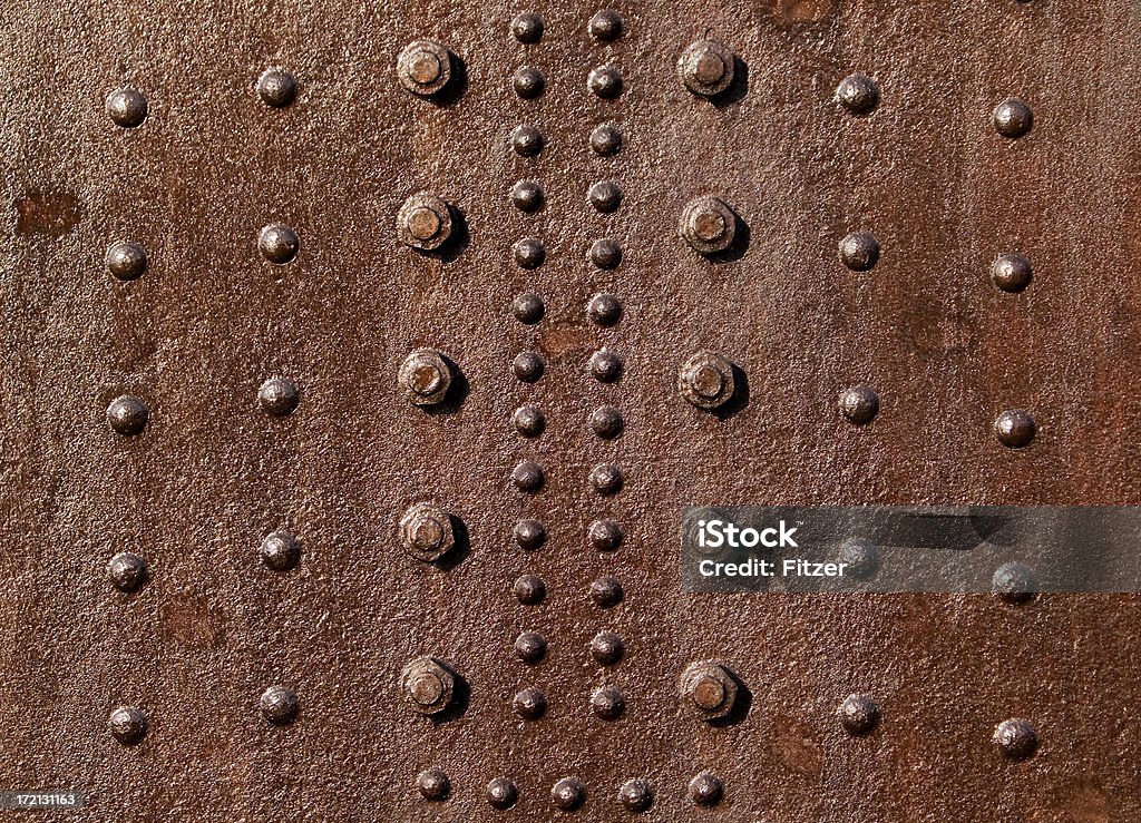 rusty red rivets rusty red vessel with a lot of rivets in the sunshine.  Aging Process Stock Photo