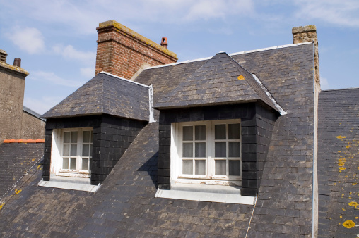 A roof with two dormers. One of the houses surrounding the monestery of Le Mont Saint Michelle in France.