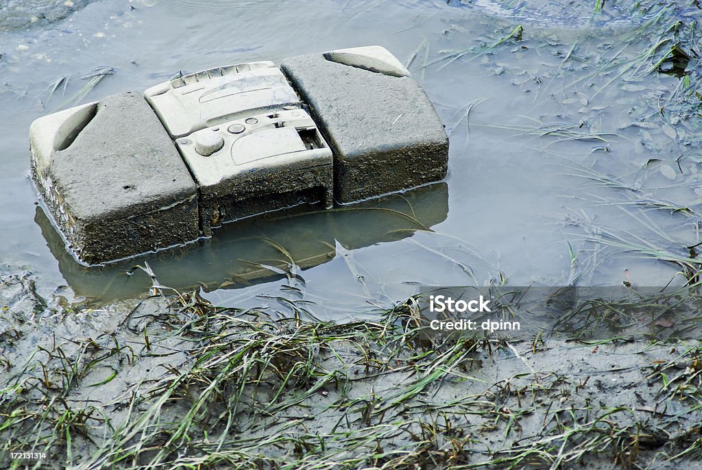 Water Music Discarded radio/cassette player lying in mud and water Analog Stock Photo