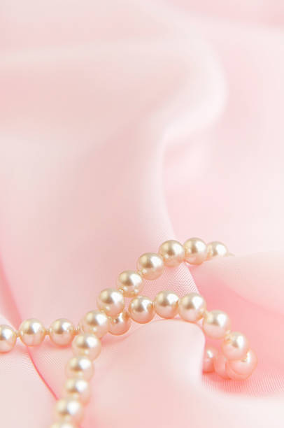 istock White pearls on rose bakground 172132323