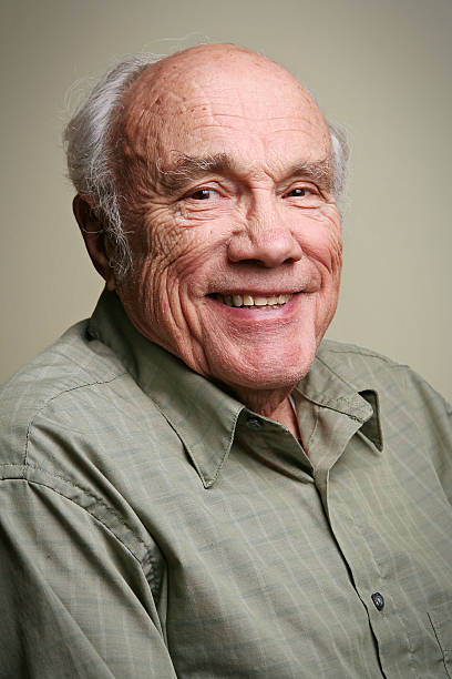 An elder man posing for the camera and smiling stock photo