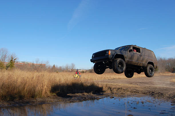 Jeep Jumping over a Puddle stock photo