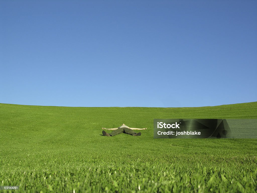 knocked out man rests in grass spread eagle style Flat - Physical Description Stock Photo