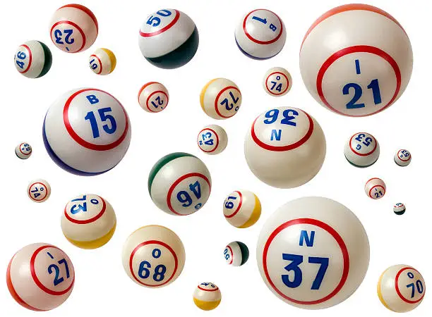 Photo of Flying Bingo balls with assorted numbers in white background