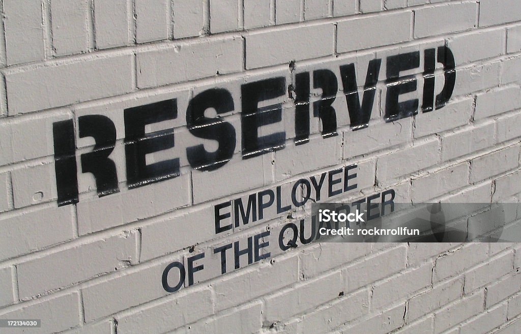 reserved shot of the stenciled phrase guarding a parking spot for the "Employee of the Quarter." Black Color Stock Photo