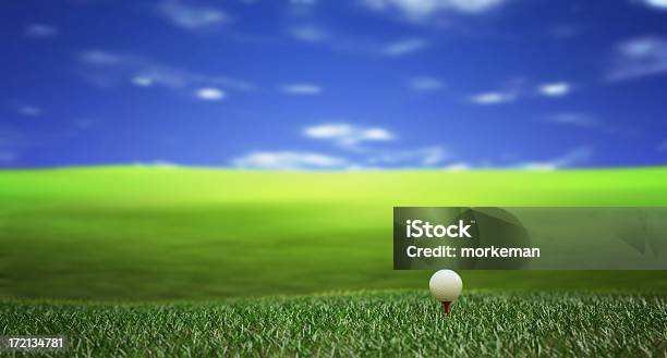 Lone Golf Ball Sitting On Green Field Under The Blue Sky Stock Photo - Download Image Now