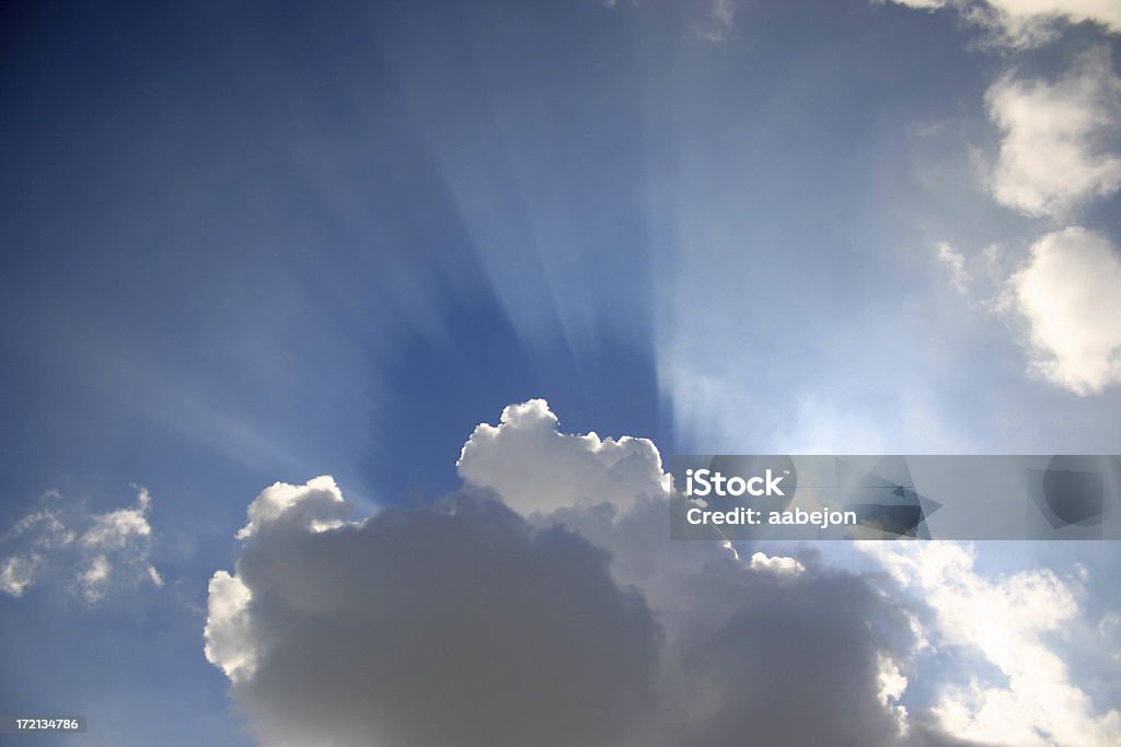 Sun Rays Clouds with the sun rays peaking out from behind Above Stock Photo