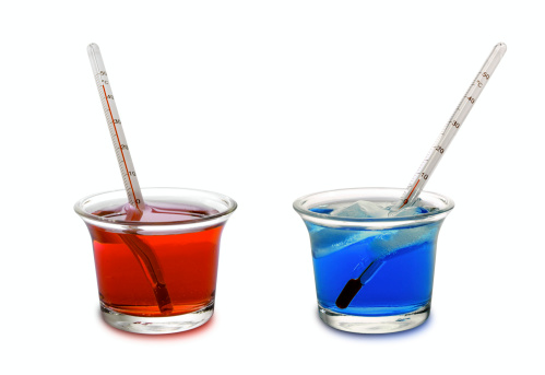 Two thermometers, one in a red cup of hot water (showing mercury high up in tube) and one in a blue cup of iced water (showing mercury low in tube).