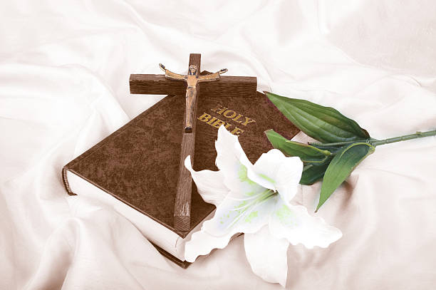 Bible with lily and crucifix, image has been sepia toned and subtle colour then re-introduced